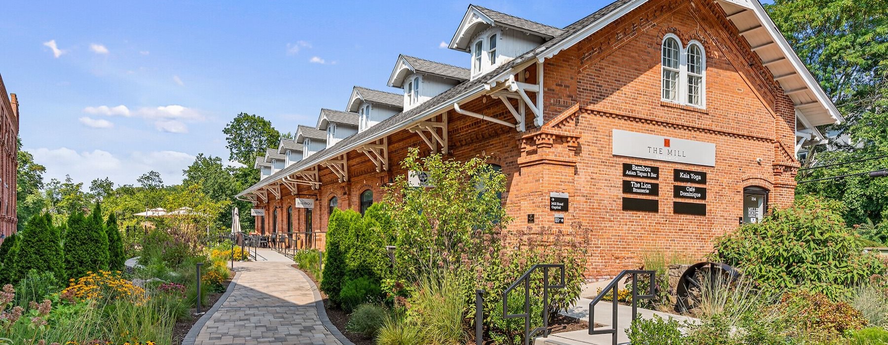 a brick building with a stone path