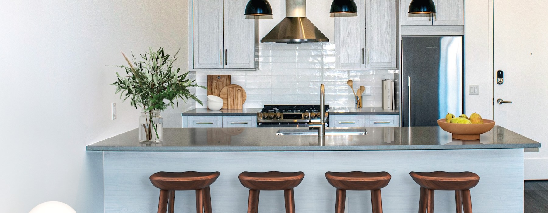 a kitchen with an island and bar stools