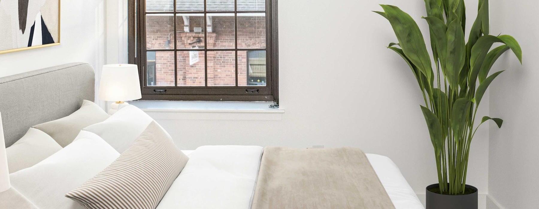 a bedroom with a bed and a plant